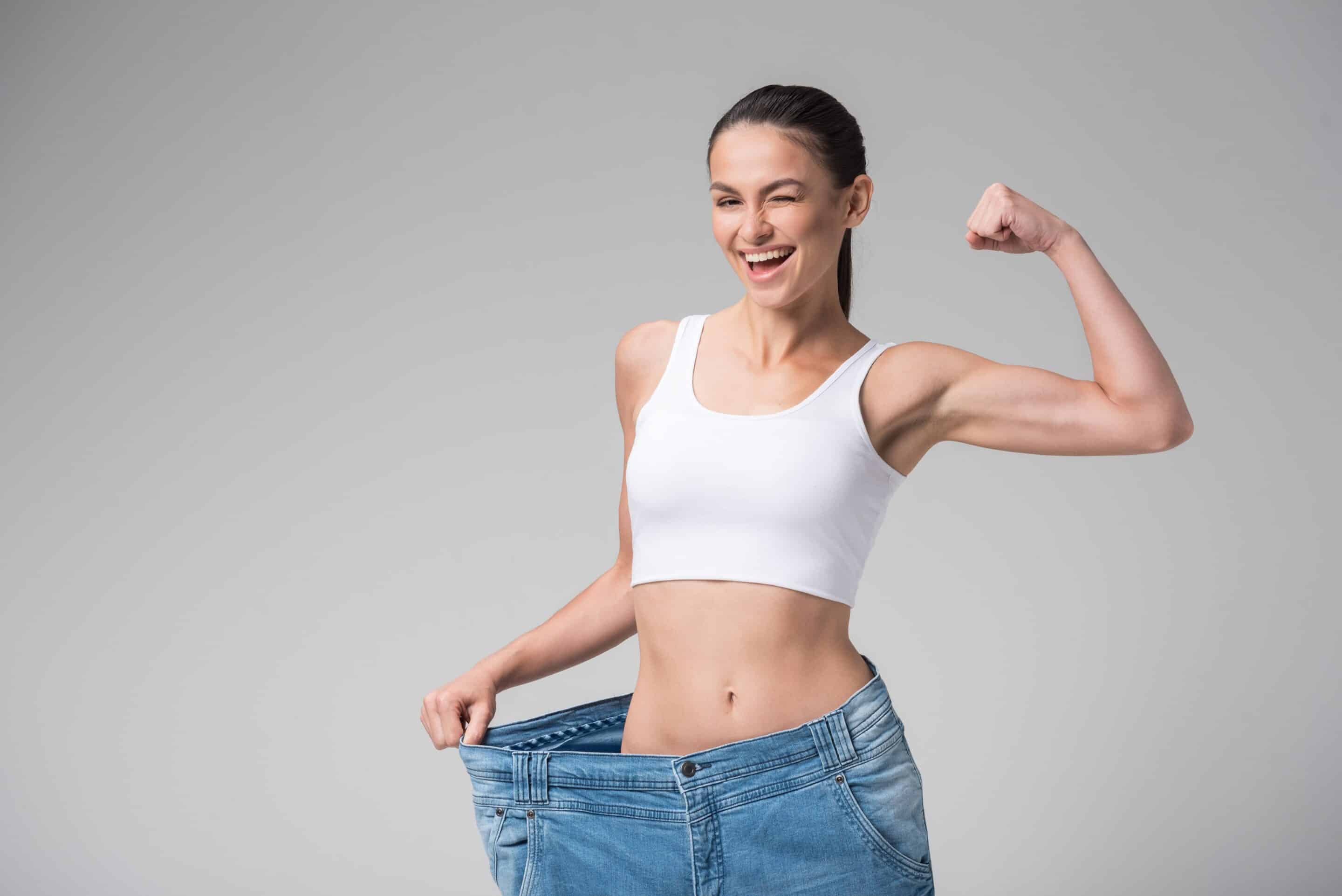 strong happy woman with oversized jeans strong happy woman with oversized jeans